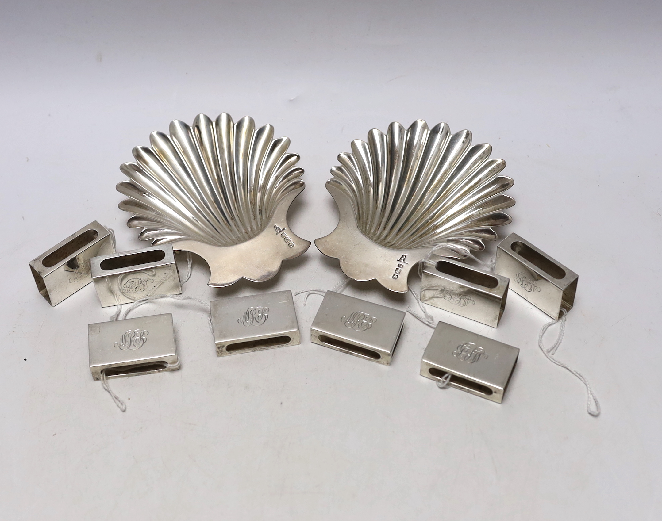 A pair of late Victorian silver butter shells, Walker & Hall, Sheffield, 1898, 12.6cm, together with a set of eight George VI silver matchbox sleeves, Birmingham, 1937.